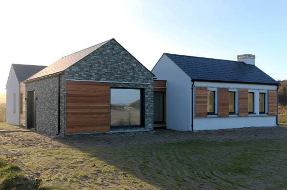 Contemporary Cottage with cedar shutters and bespoke track system in exposed coastal environment